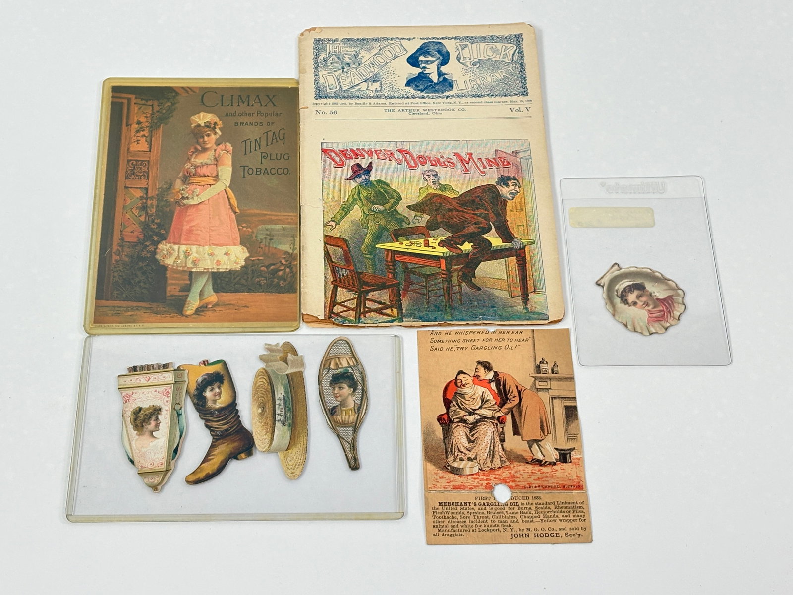 1899 DEADWOOD DICK MAGAZINE & ADVERTISING TRADE CARDS: ALL REMAIN IN FAIR TO GOOD CONDITION, SHOWING SOME TYPICAL WEAR.