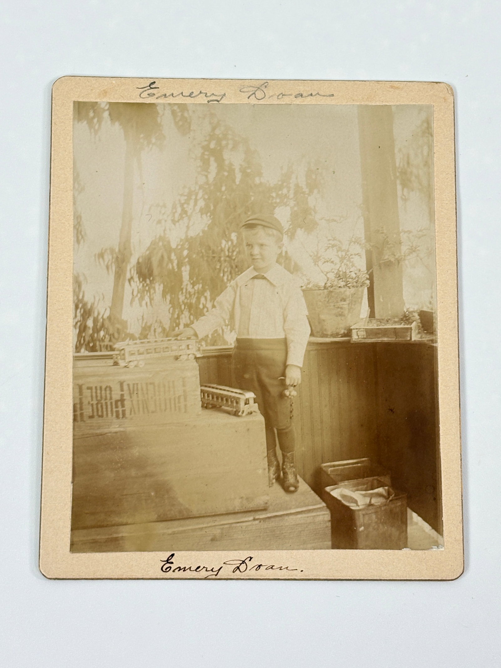 ANTIQUE PHOTOGRAPH BOY WITH IRON TRAIN & MARBLE BAG: REMAINS IN GOOD CONDITION, SHOWING SOME WRITING ON.