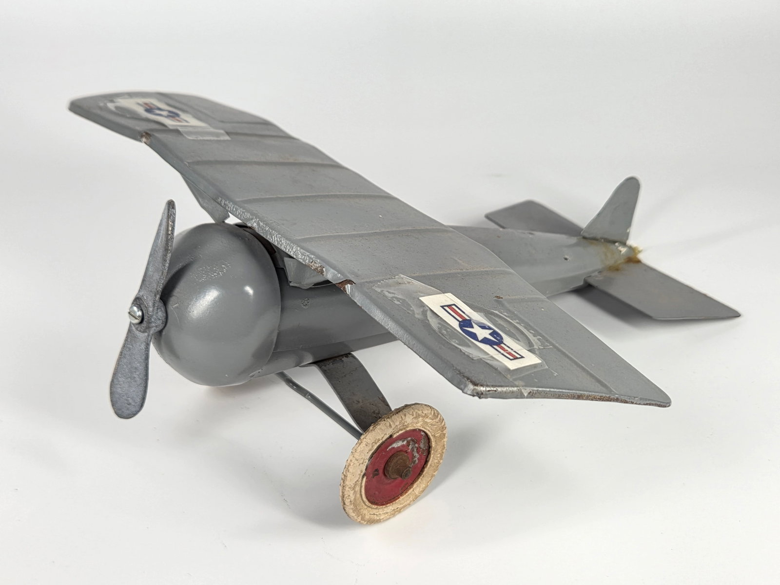 PARTIALLY RESTORED KINGSBURY PRESSED STEEL WIND UP AIRPLANE: REMAINS IN FAIR PARTIALLY RESTORED CONDITION. REPLACED REAR WINGS AND PROPELLER. DECALS TAPED ON. LARGE WING WITH BENDS AND POR PAINT.