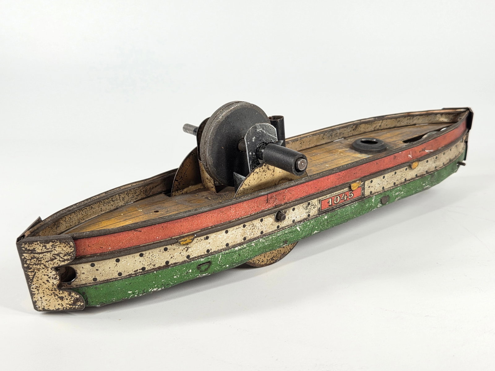 GERMAN TIN LITHO FLYWHEEL BOAT SHIP: REMAINS IN FAIR CONDITION, SHOWING TYPICAL USAGE WEAR THROUGHOUT.