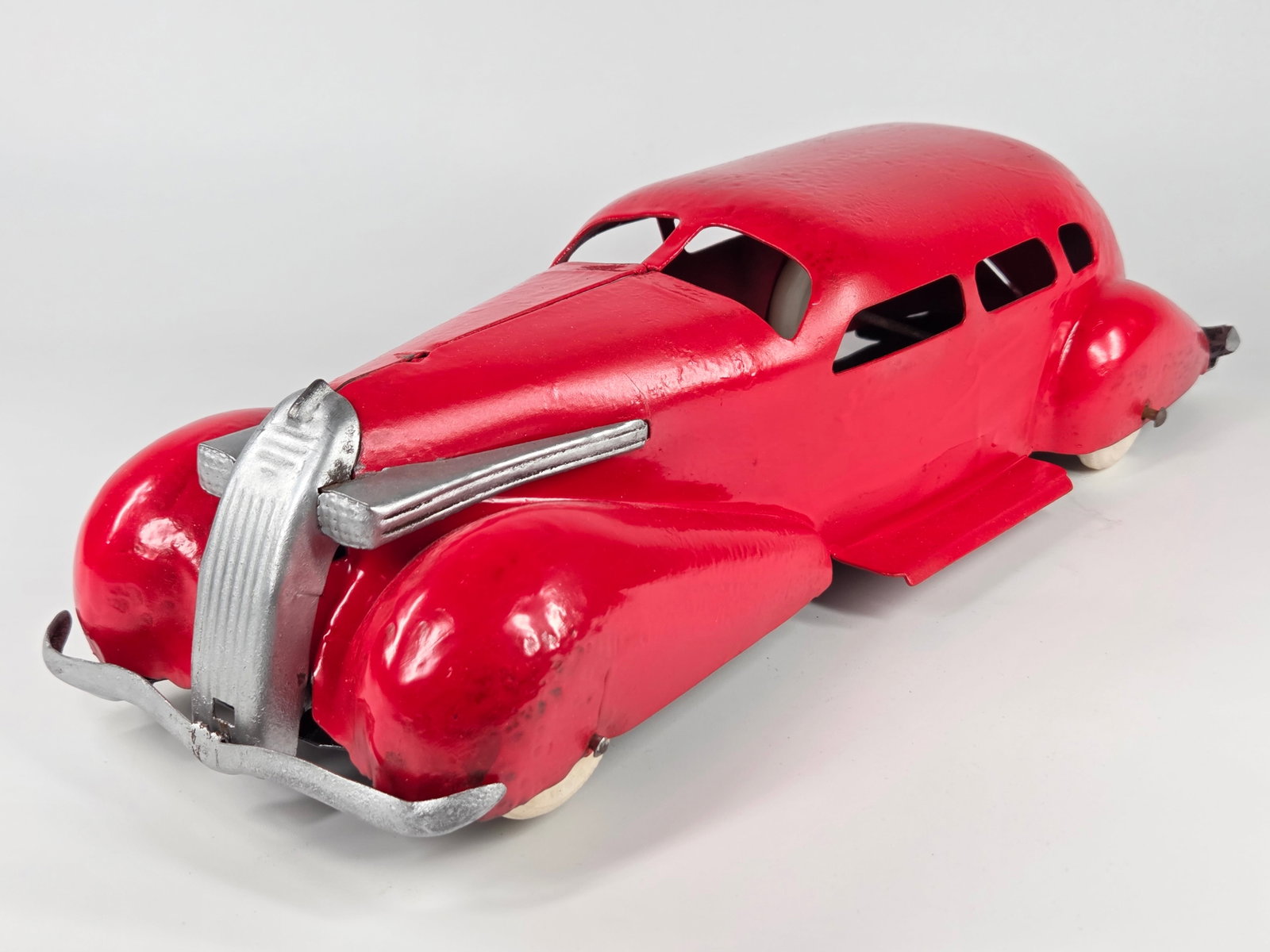 RESTORED WYANDOTTE PRESSED STEEL STREAMLINE AUTO: REMAINS IN FAIR RESTORED CONDITION, SHOWING WEAR AND BENDS TO METAL.