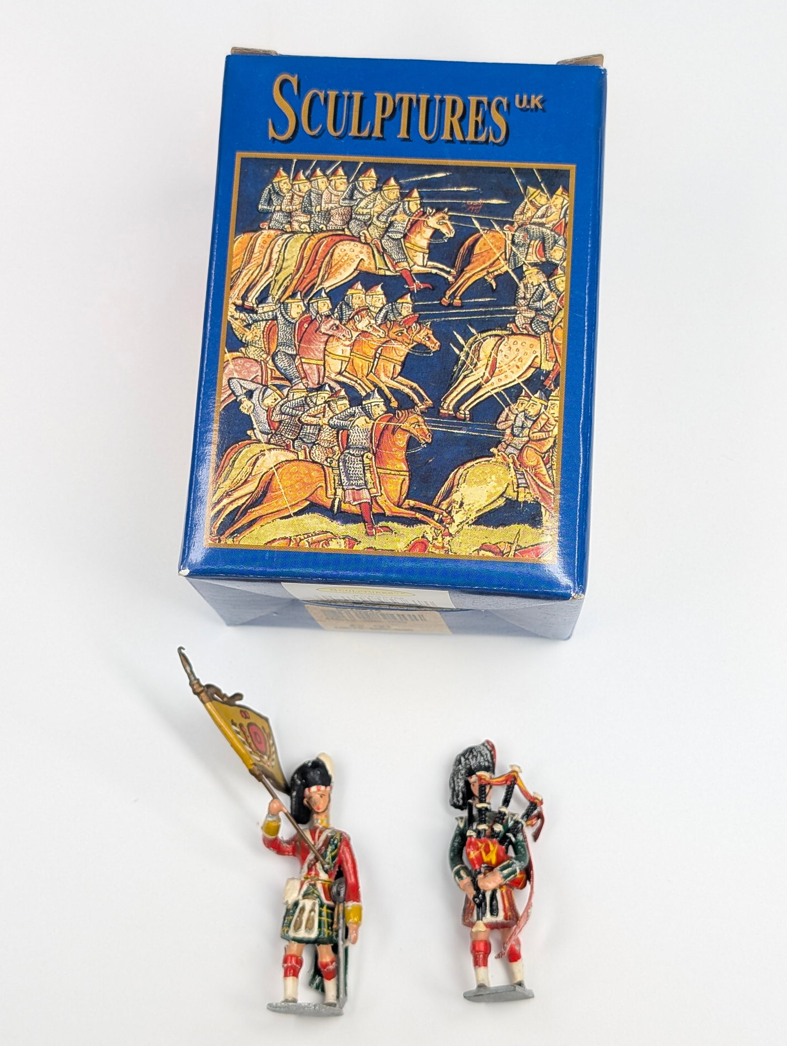 SCULPTURES U.K. FLAG BEARER & BAGPIPES: BOTH REMAIN IN GOOD CONDITION, SHOWING SOME PAINT WEAR.