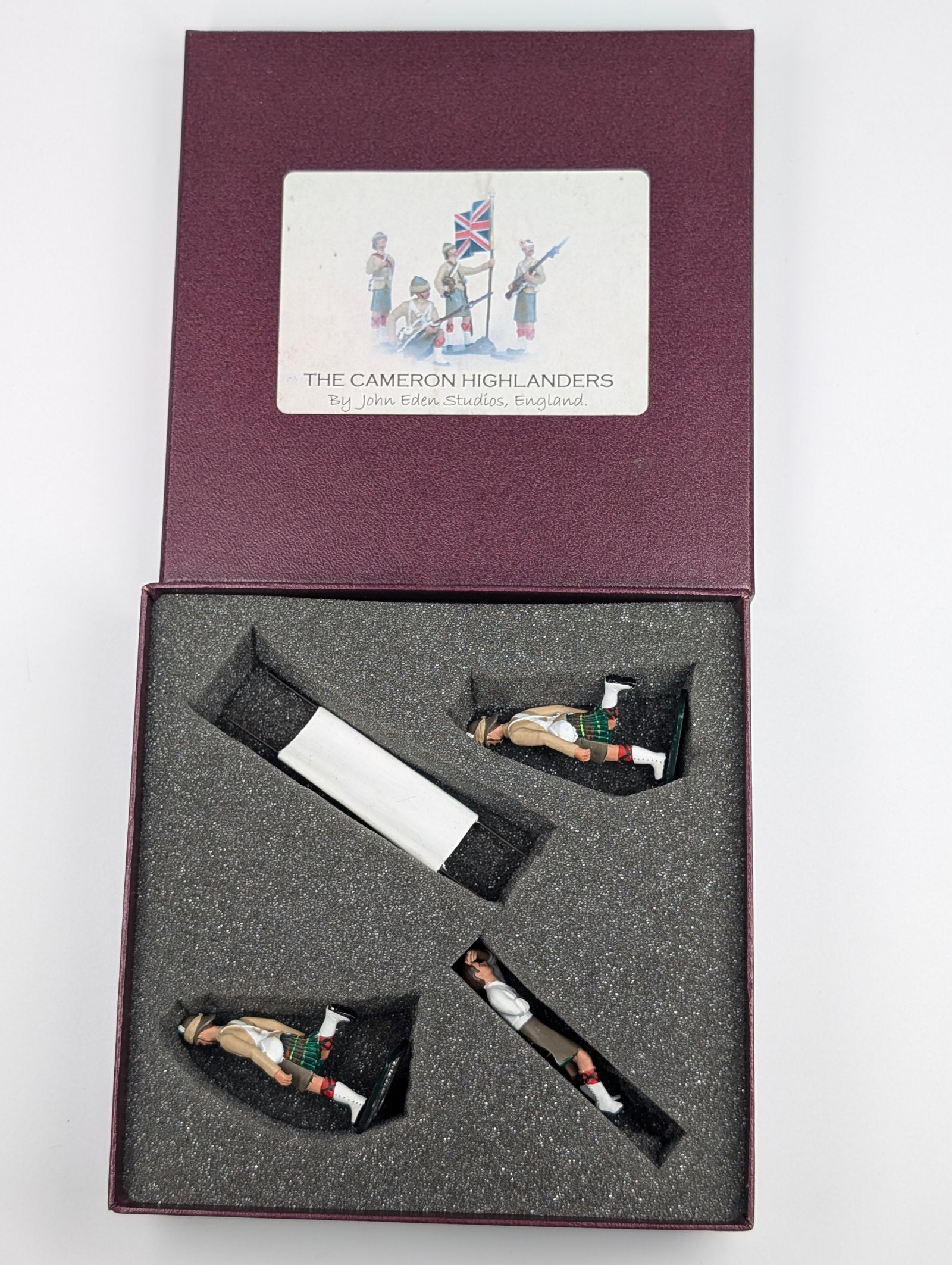 JOHN EDEN STUDIOS THE CAMERON HIGHLANDERS STRETCHER TEAM: SET REMAINS IN VERY GOOD CONDITION WITH BOX.