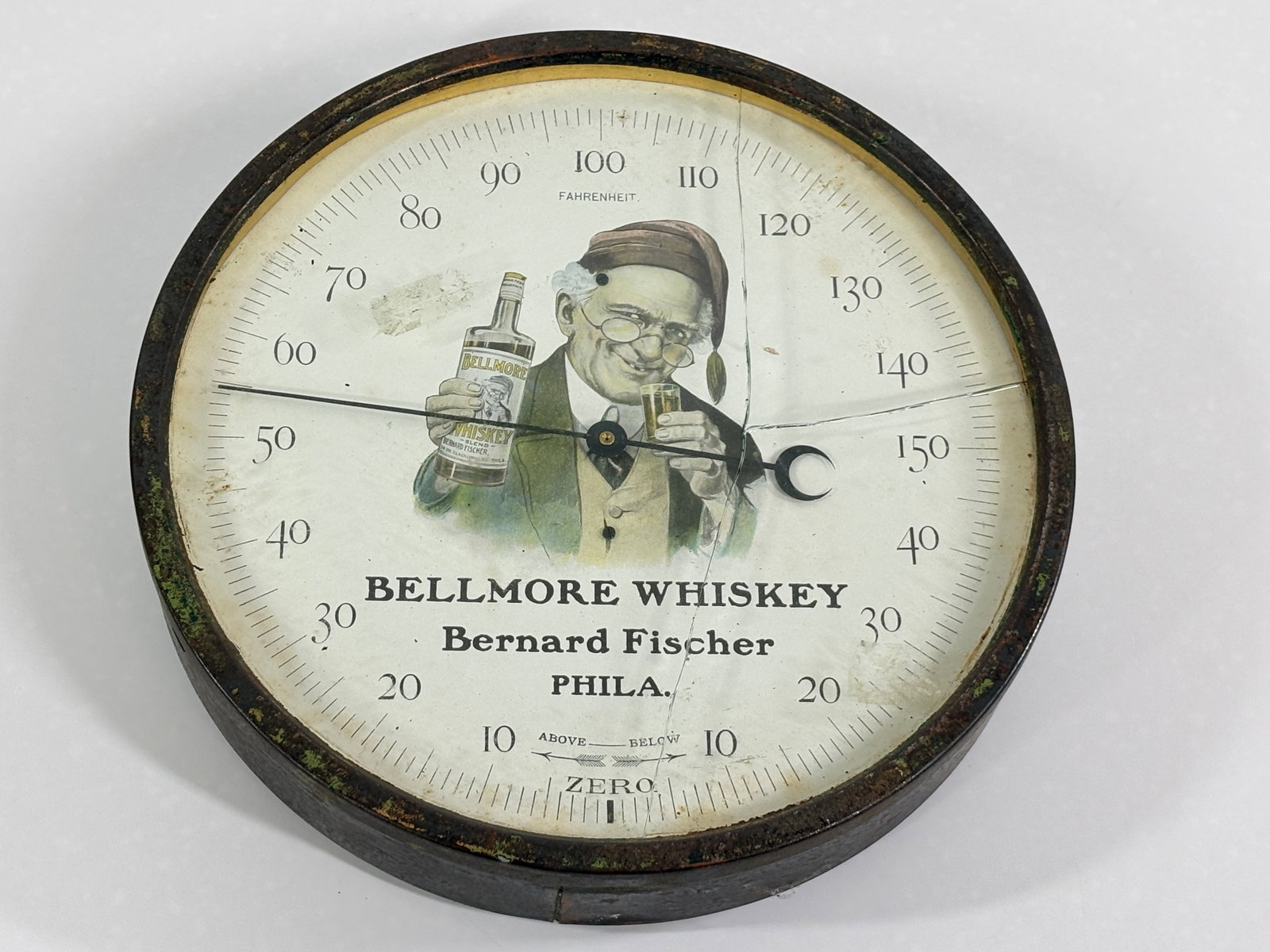 BELLMORE WHISKEY PHILA. PA ADVERTISING THERMOMETER: REMAINS IN FAIR CONDITION, SHOWING SOME TYPICAL WEAR THROUGHOUT. CRACK IN GLASS AS SHOWN.