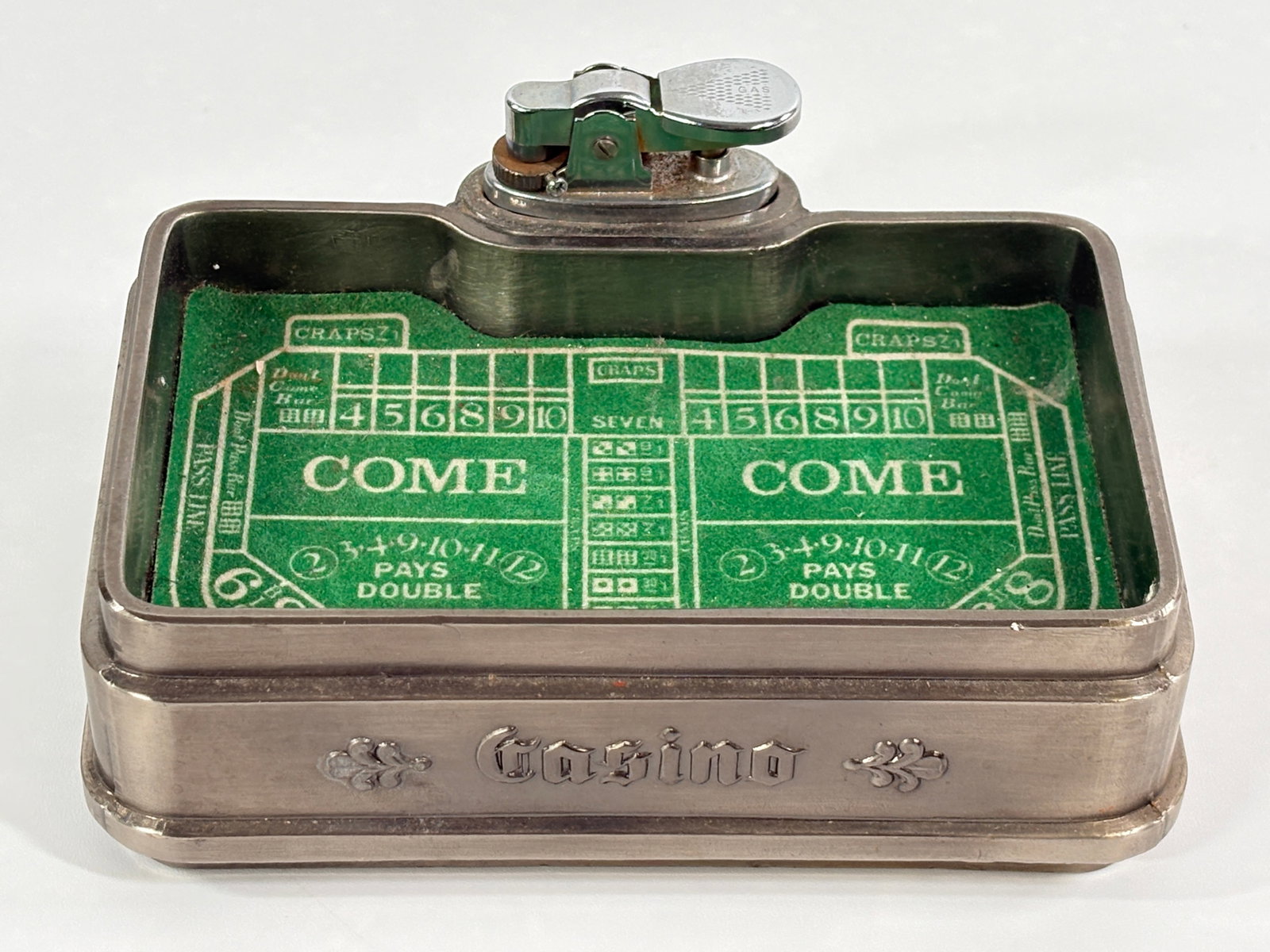 VINTAGE CASINO CRAPS TABLE TOP LIGHTER: REMAINS IN GOOD CONDITION, SHOWING SOME TYPICAL WEAR.