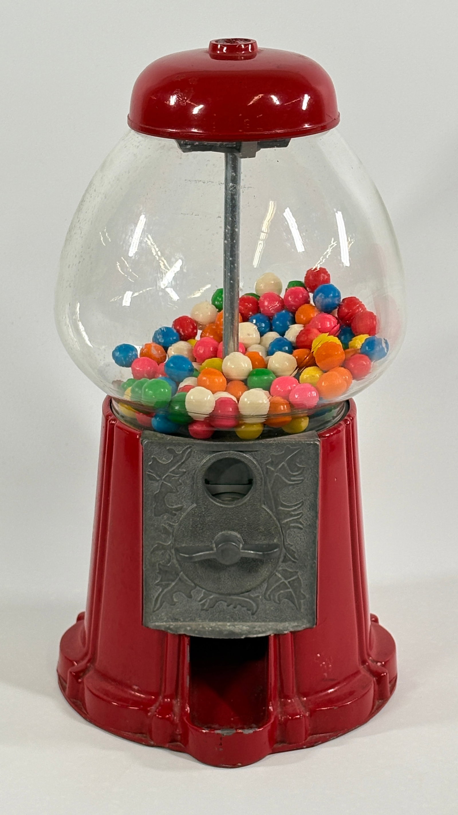 VINTAGE RED GUMBALL MACHINE: REMAINS IN GOOD CONDITION, SHOWING TYPICAL USAGE WEAR.