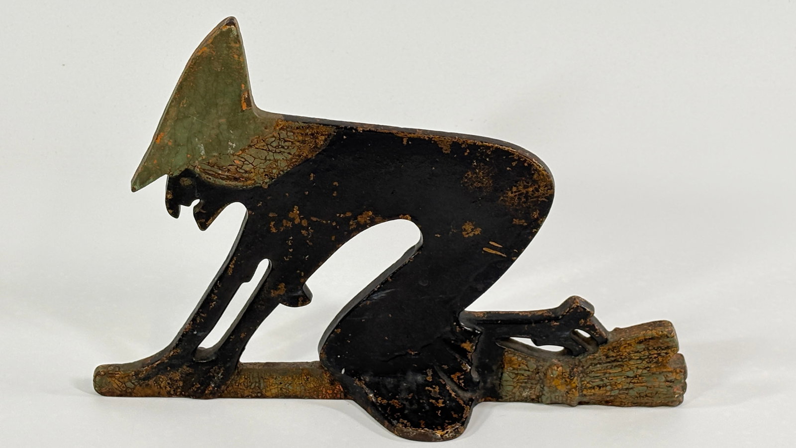 ANTIQUE CAST IRON HALLOWEEN WITCH DOORSTOP BOOT SCRAP: REMAINS IN FAIR TO GOOD CONDITION, SHOWING PAINT WEAR.