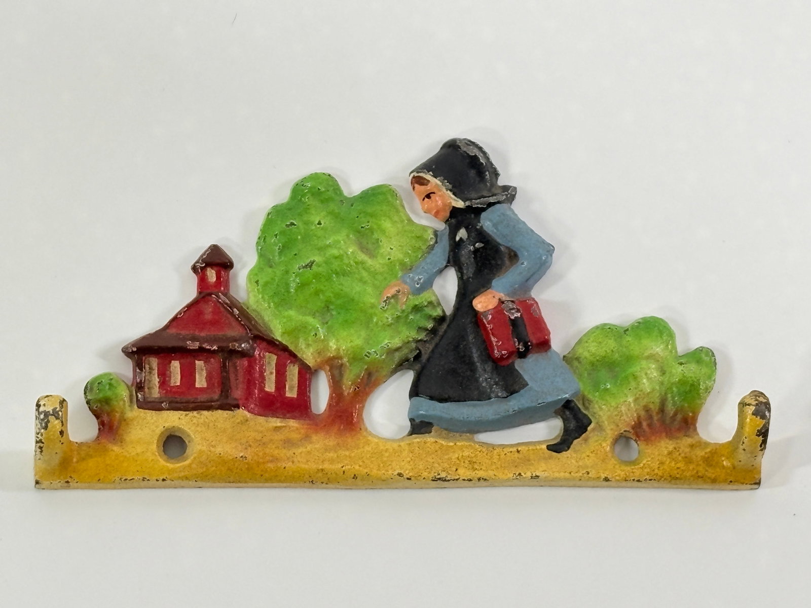 PAINTED CAST IRON AMISH SCHOOL WALL HOOK: REMAINS IN GOOD CONDITION, SHOWING SOME PAINT WEAR.