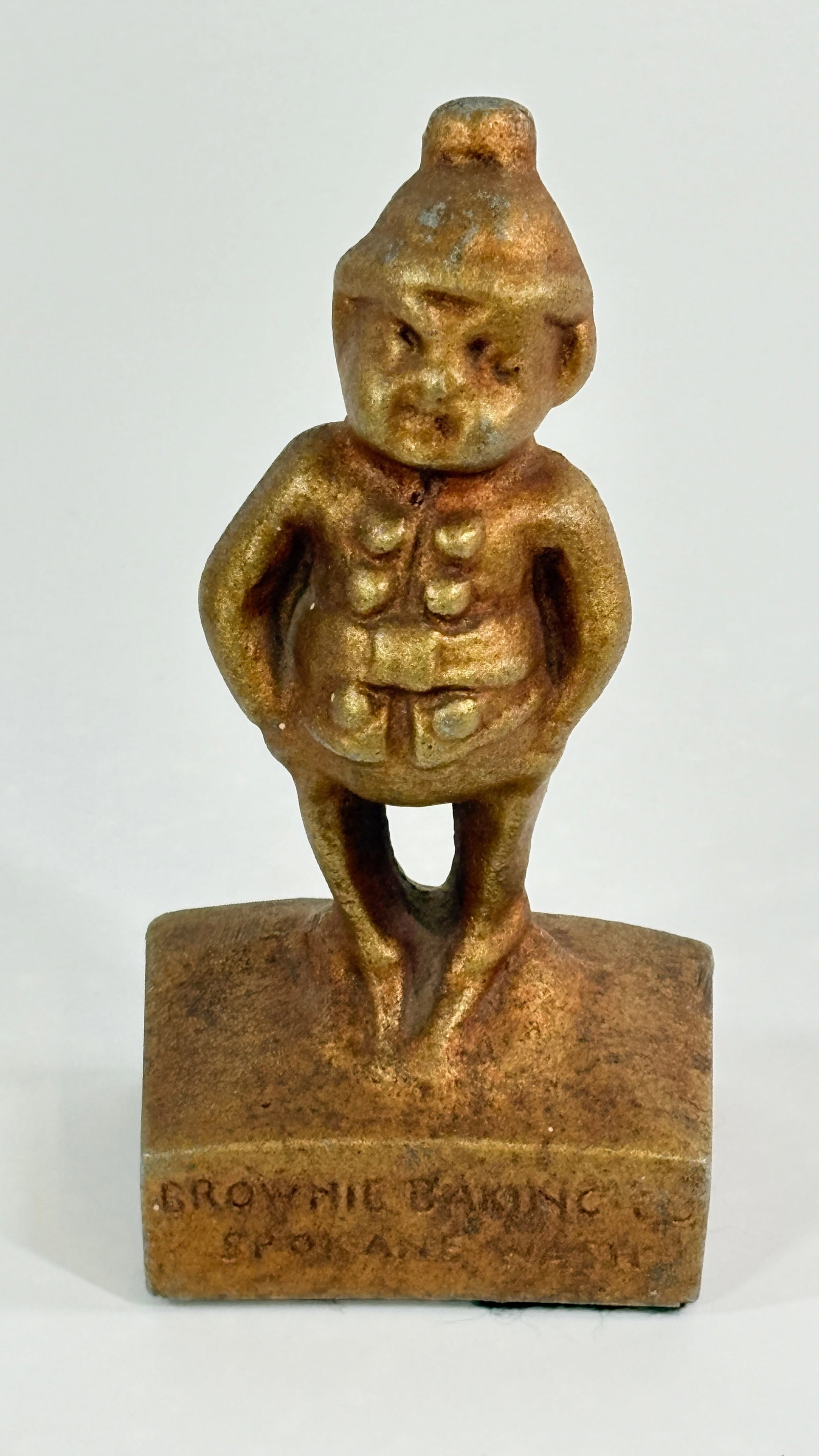 CAST IRON BROWNIE BAKING CO. BROWNIE STATUE: REMAINS IN FAIR TO GOOD CONDITION, SHOWING WEAR.