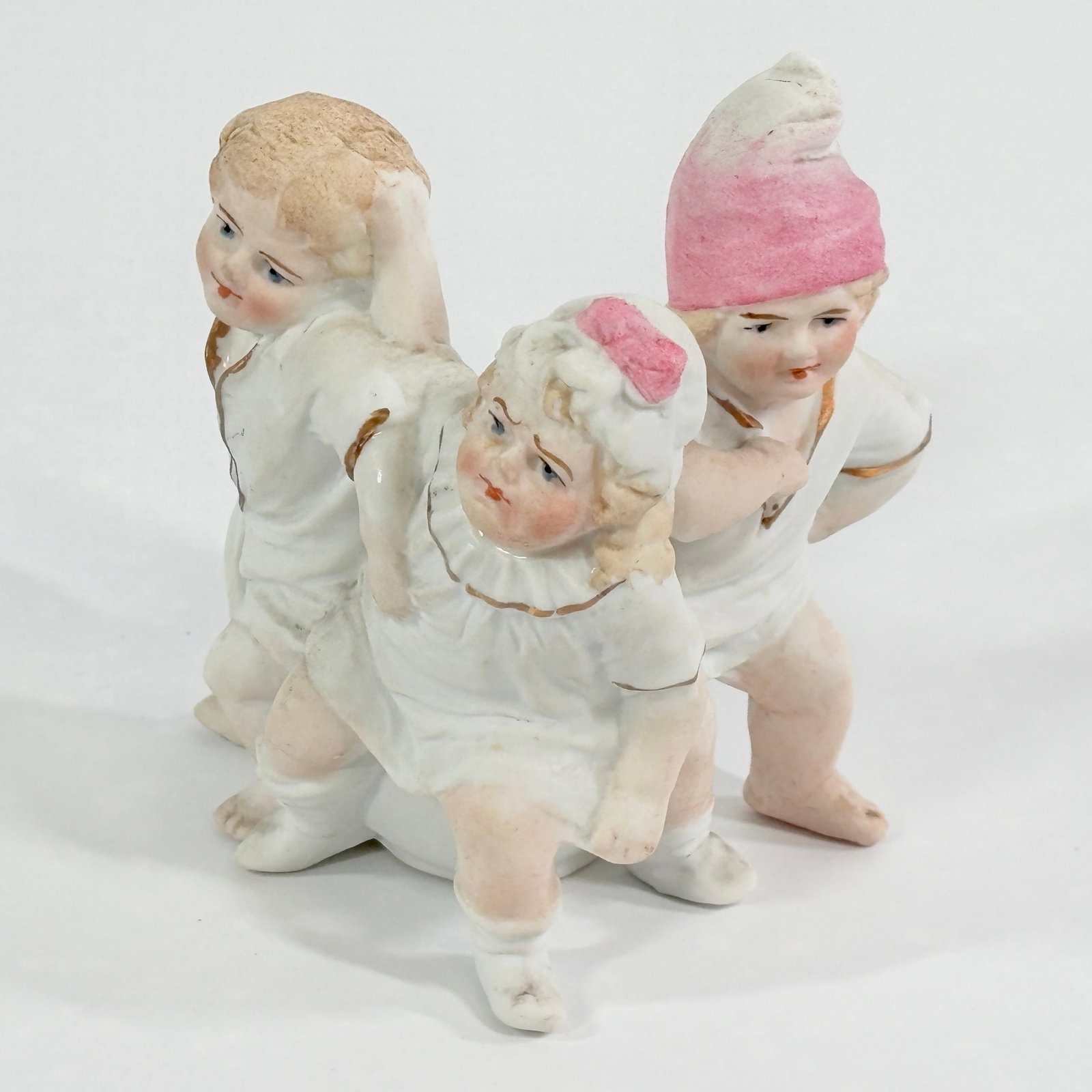 ANTIQUE GERMAN BISQUE CHILDREN ON CHAMBER POT: REMAINS IN GOOD CONDITION, SHOWING SOME RUBS.