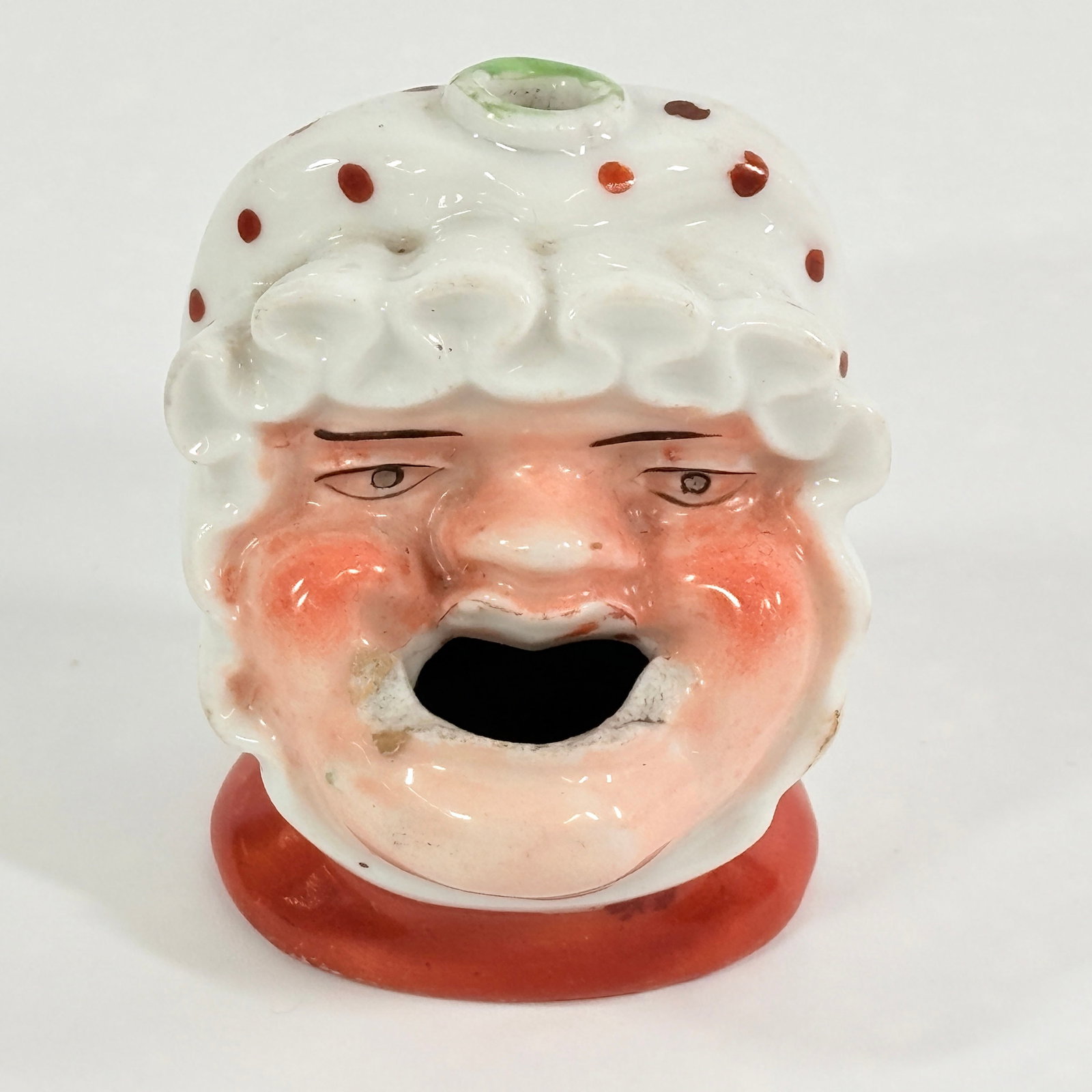 ANTIQUE FIGURAL WOMAN HEAD PORCELAIN PAINTED INKWELL: REMAINS IN GOOD CONDITION, SHOWING SOME TYPICAL WEAR. SMALL CHIP ALONG BOTTOM EDGE. NEEDS CLEANED.