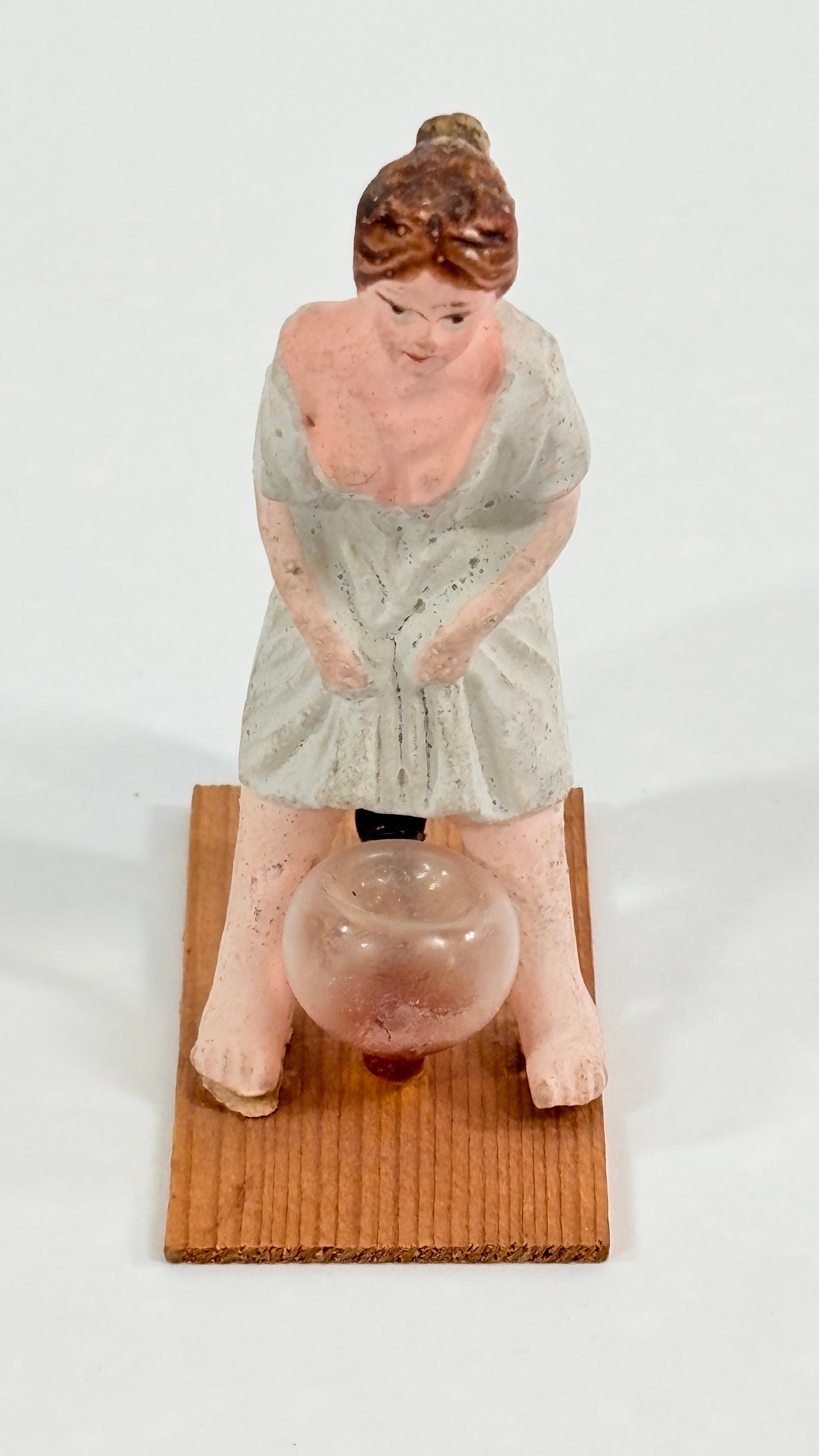 ANTIQUE COMPOSITION & GLASS NAUGHTY GIRL W/ CHAMBER POT: REMAINS IN GOOD CONDITION, SHOWING SOME TYPICAL WEAR. PAINT WEAR AS SHOWN.