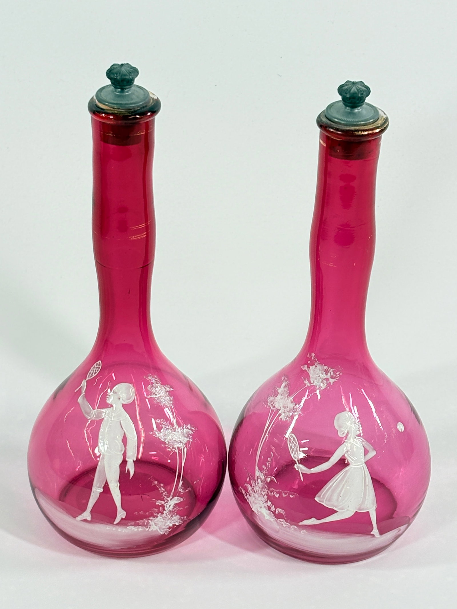 PAIR OF ANTIQUE CRANBERRY MARY GREGORY BARBER TONIC BOTTLES: BOTH REMAIN IN VERY GOOD CONDITION, NO CHIPS OR CRACKS.