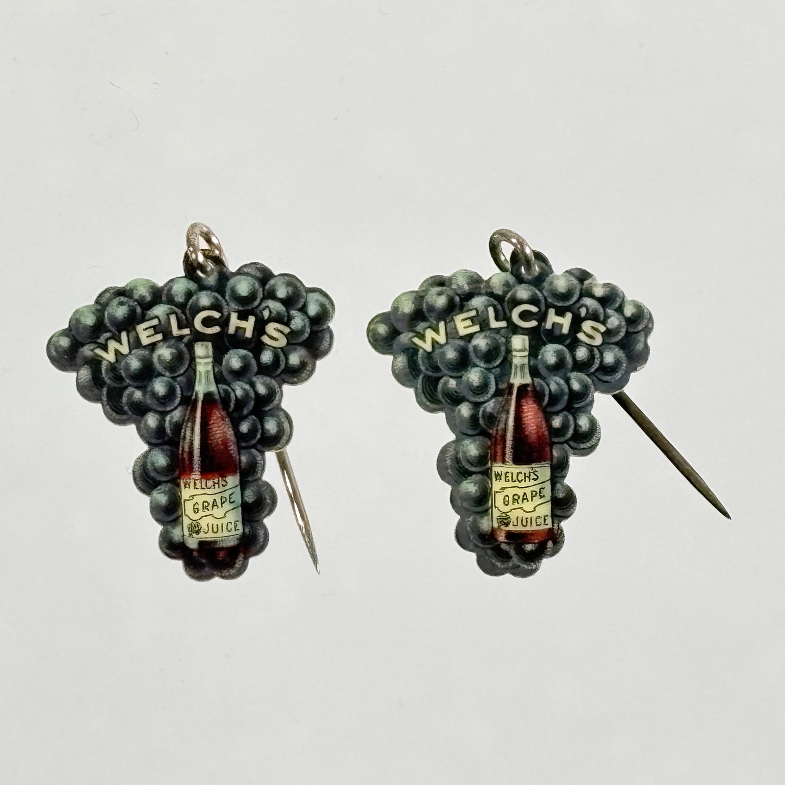 PAIR OF WELCH'S GRAPE JUICE CELLULOID PINS: BOTH REMAIN IN GOOD CONDITION.