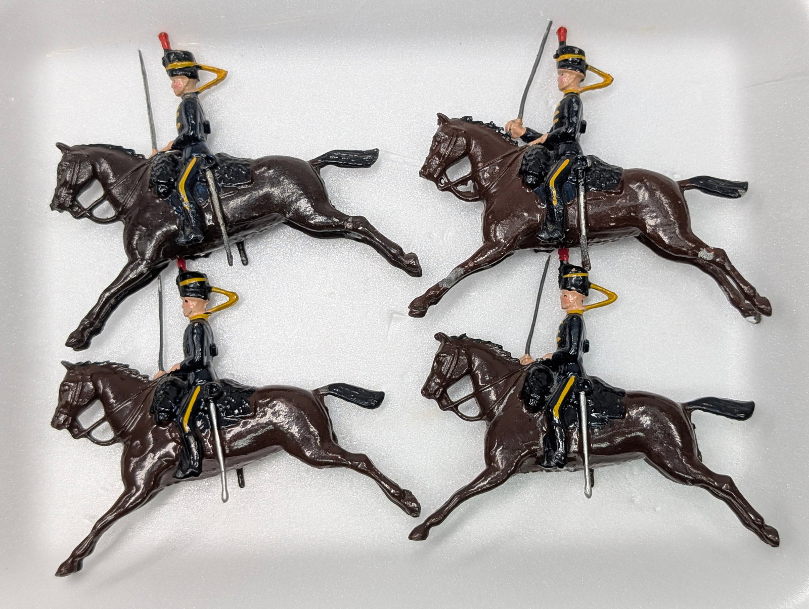 4) VINTAGE BRITAIN MOUNTED SOLDIERS: ALL REMAIN IN FAIR TO GOOD CONDITION, SHOWING SOME TYPICAL WEAR.