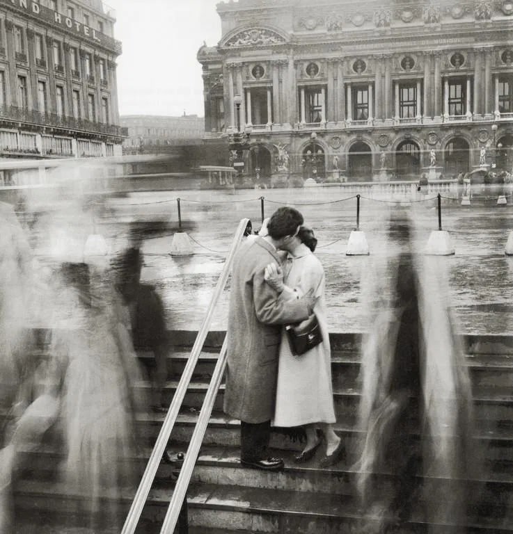 Robert Doisneau - The Kiss at the Opera, 1950: Robert Doisneau - The Kiss at the Opera, 1950. Photolitho. Measures: 9 x 9 1/4 inches.