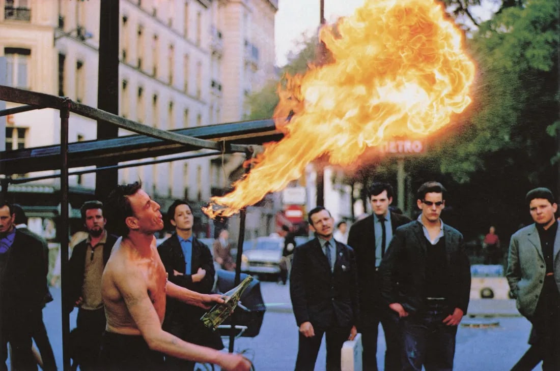 Joel Meyerowitz - Street Busker, Paris, 1967: Joel Meyerowitz - Street Busker, Paris, 1967. Photolitho. Measures: 8 1/2 x 5 3/4 inches.