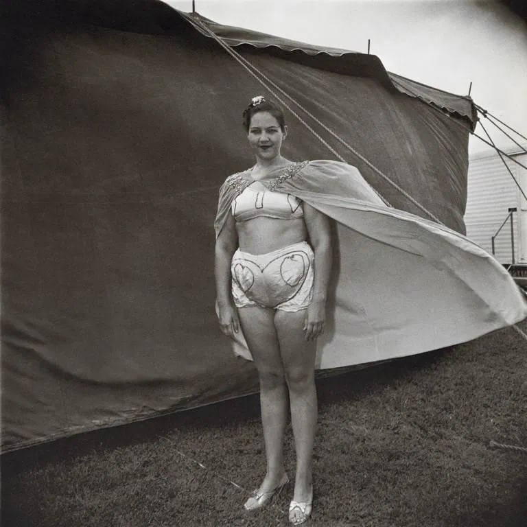Diane Arbus - Girl in her Costume, MD, 1970: Diane Arbus - Girl in her Costume, MD, 1970. Photolitho. Measures: 8 1/3 x 8 1/3 inches.