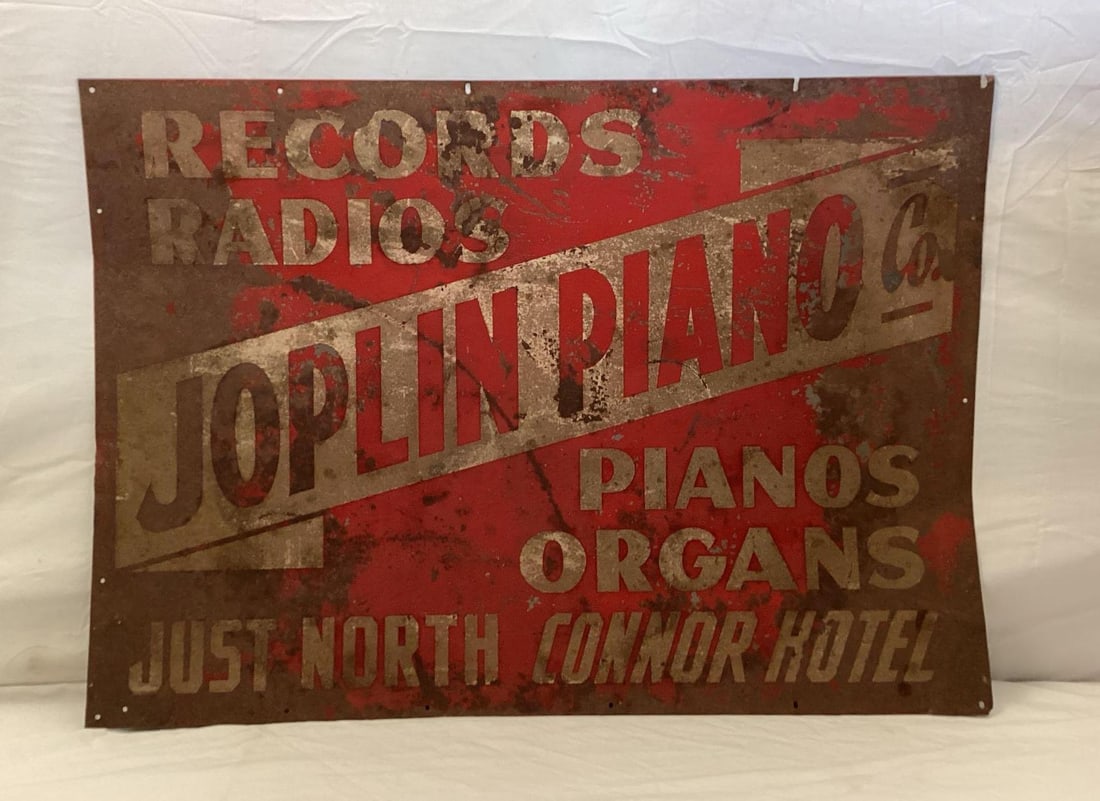 Joplin Piano Company Metal Sign: Joplin Piano Company metal sign. Rare sign advertises records, radios, pipe organs and pianos. Great piece from Joplin, Missouri presents with nice color and some wear. Measures 28 x 20.