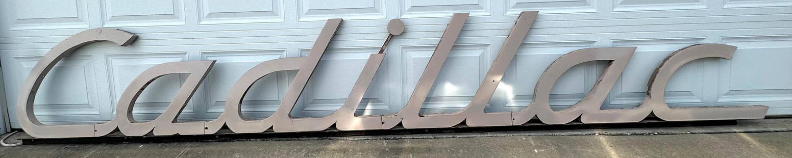13ft. Cadillac Porcelain Script Sign: Cadillac script single sided porcelain cookie-cutter dealership sign. Custom manufactured for Bob Moore Cadillac in Edmond, OK and hung over awning entrance. Unique dark cream color porcelain is stron