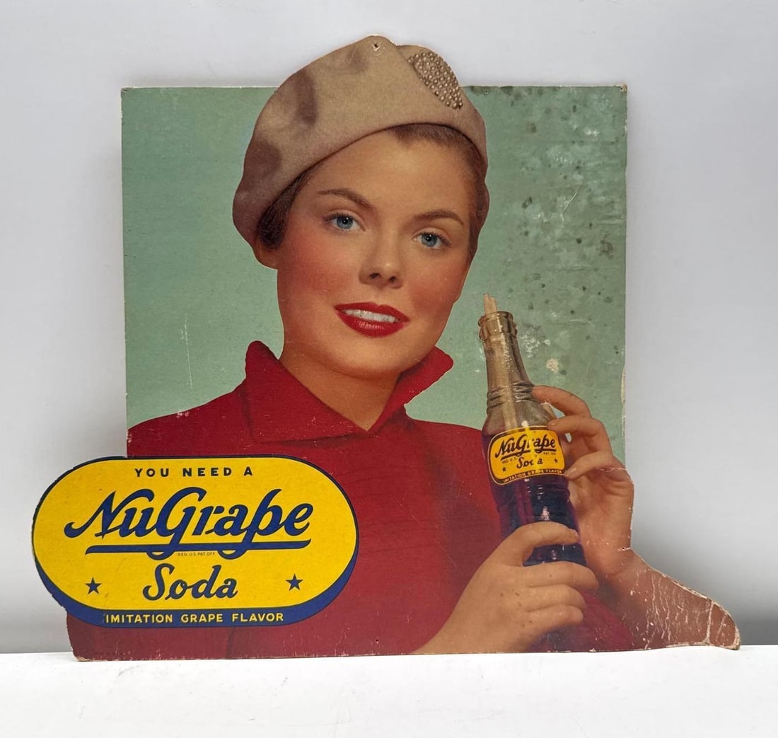 "You Need a NuGrape Soda" Cardboard Easel Sign: "You Need a NuGrape Soda" Cardboard Easel Sign. Measures 15x10.