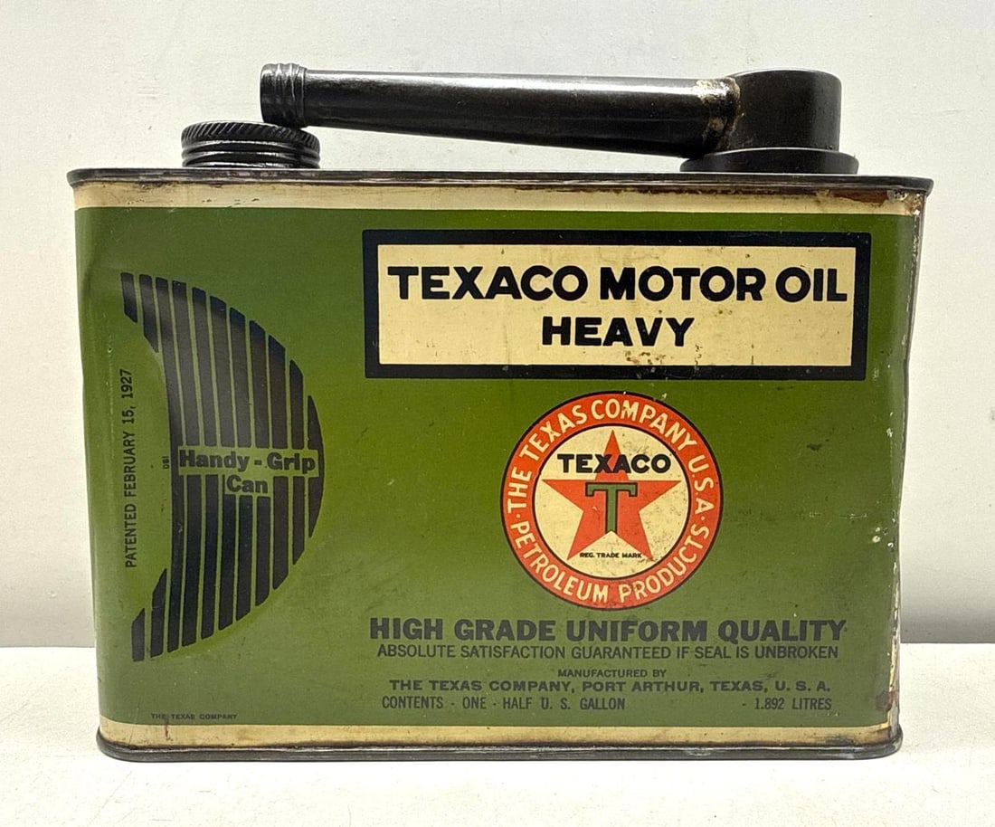 1920's Texaco 1/2 Gallon Motor Oil Can: Texaco Motor Oil 1/2 gallon can. Features pouring handle indentation design and early Texaco logo on all four sides. Presents with strong color and light wear.