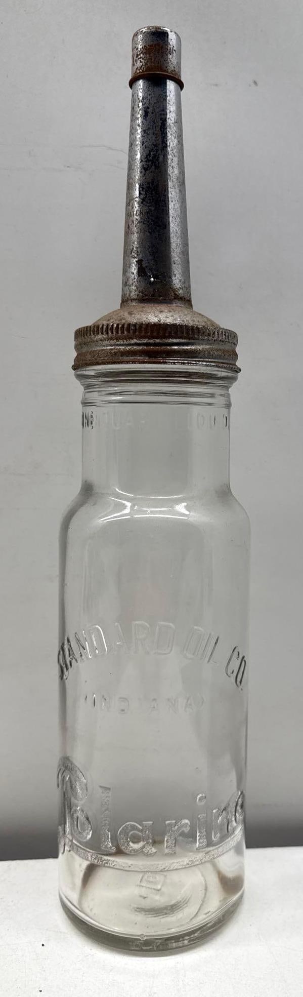 1920's Standard Polarine Quart Oil Bottle: Polarine quart oil bottle dating to the 1920's with the original spout.? Features raised letter Polarine in Script and Standard in block letters.? Measures 15".