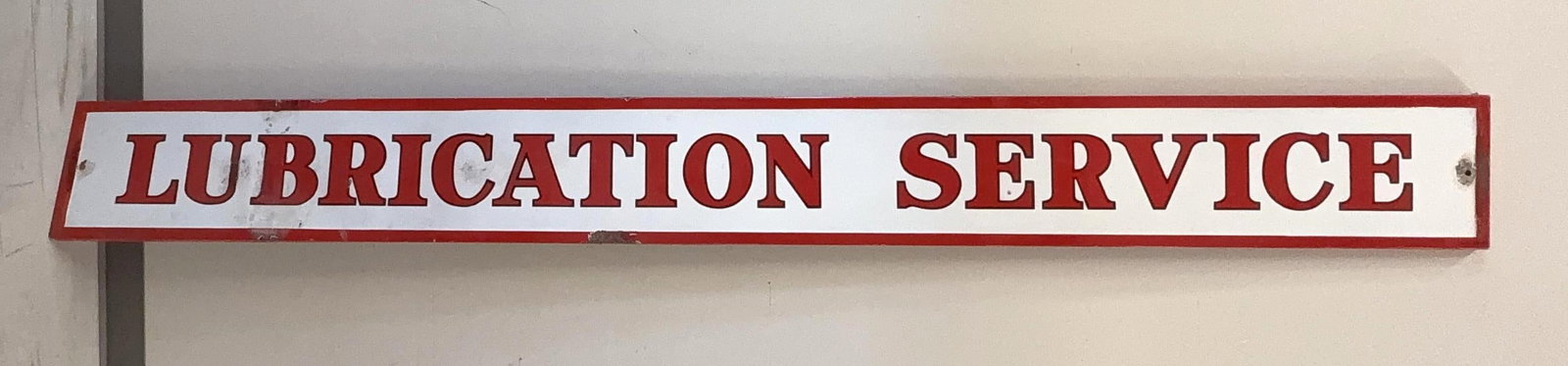 Skelly "Lubrication" Porcelain Sign: Skelly Lubrication single sided self-framing "cookie cutter" style porcelain sign. This filling station bay sign dates to the 1930's and presents with nice color and a few chips. Measures 12x114.