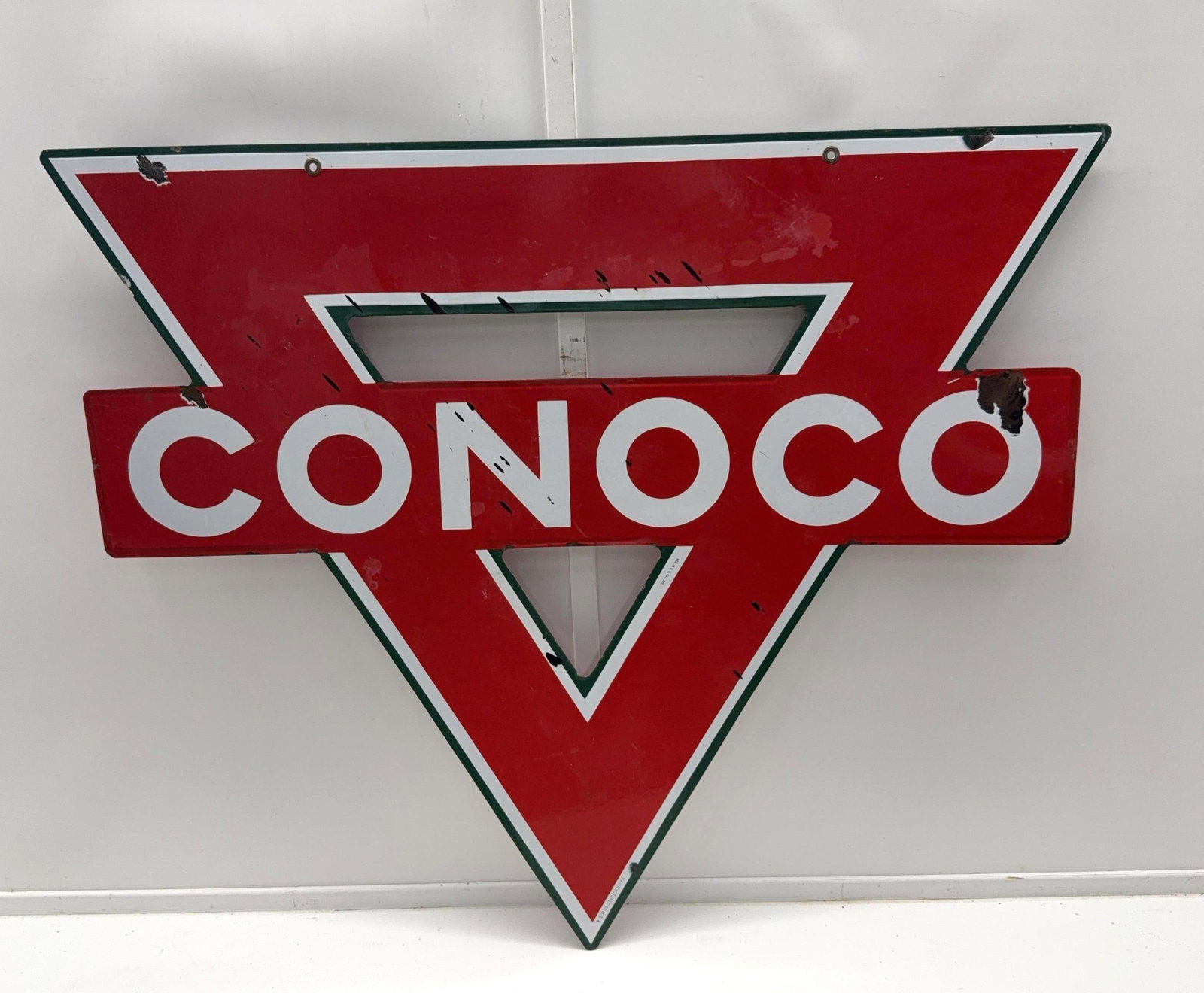 42" Conoco Gasoline Porcelain Die-Cut Triangle Sign: Conoco Gasoline double sided sign. Die-Cut triangle shaped sign, marked "Reg US Pat Off" and features the green triangle. Presents with nice color, light wear and tar stains (that will clean). Measure