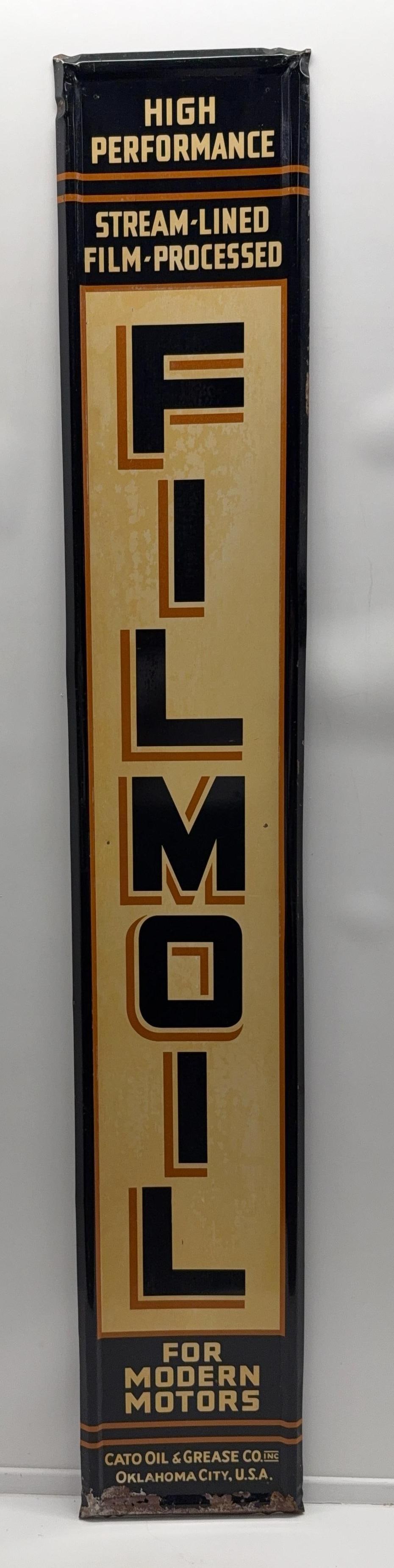 6ft Filmoil Oils & Greases Metal Sign: Filmoil embossed single sided metal sign. Reads Cato Oils & Greases Co. Oklahoma City, OK. Presents with fair color and some staining. Measures 71x12