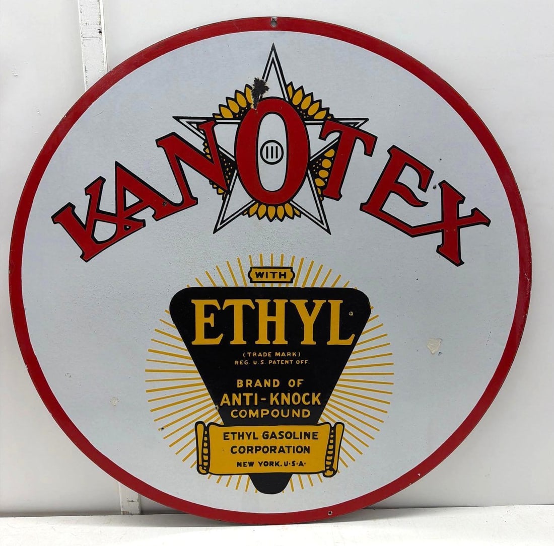 30" Kanotex Ethyl Porcelain Sign: Kanotex Ethyl double sided porcelain sign.? Features Kanotex logo with Texas Star, Kansas Sunflower and Red "O".? Presents with strong color, light wear with older touch-up.? Measures 30"