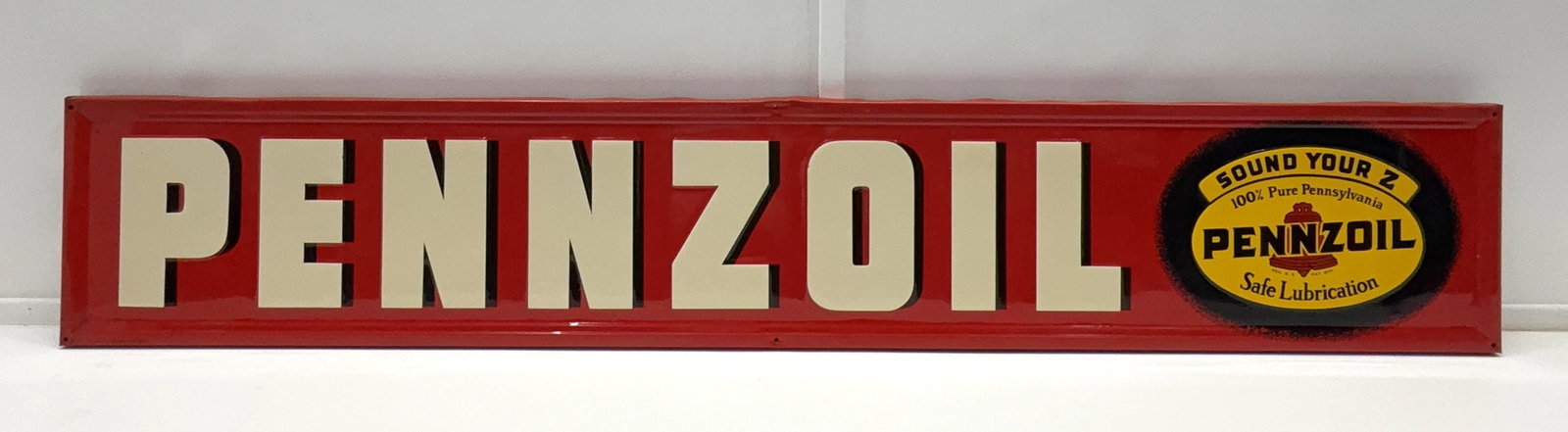 1951 Pennzoil "Sound Your Z" Embossed Metal Sign: Pennzoil "Sound Your Z" embossed metal sign with original wood back.? Dated 1951 and presents with strong color and light wear.? Measures 12x70.