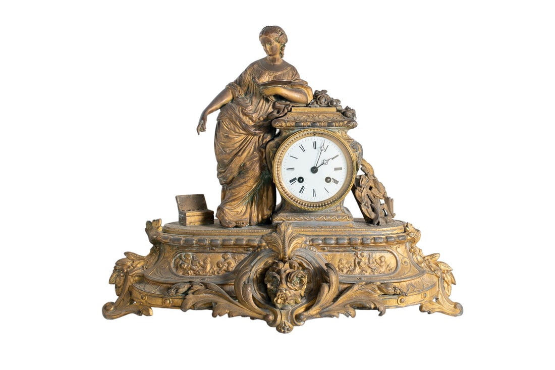 19th Century French Gilt Brass Metal Ormolu Mantel Clock: Early 20th-century French gilt brass mantel clock, surmounted with a classical figure, opposing a white enamel Roman numeral drum dial striking on a bell. Raised up on a plinth molded with foliate det