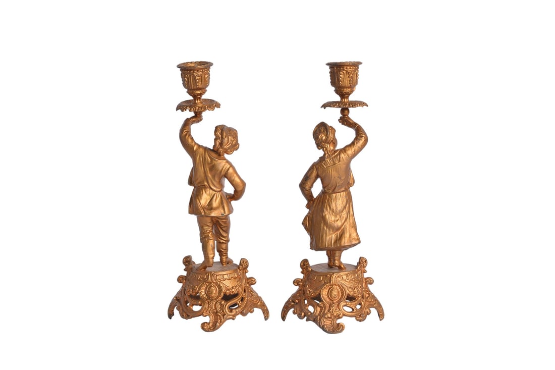 Pair of Early 20th Century French Liberty Style Gilded Brass Candle Holder: Add a touch of elegance to your decor with this pair of Early 20th Century French Liberty Style Gilded Brass Candle Holders. Featuring intricate male and female figures, these candle holders accommoda