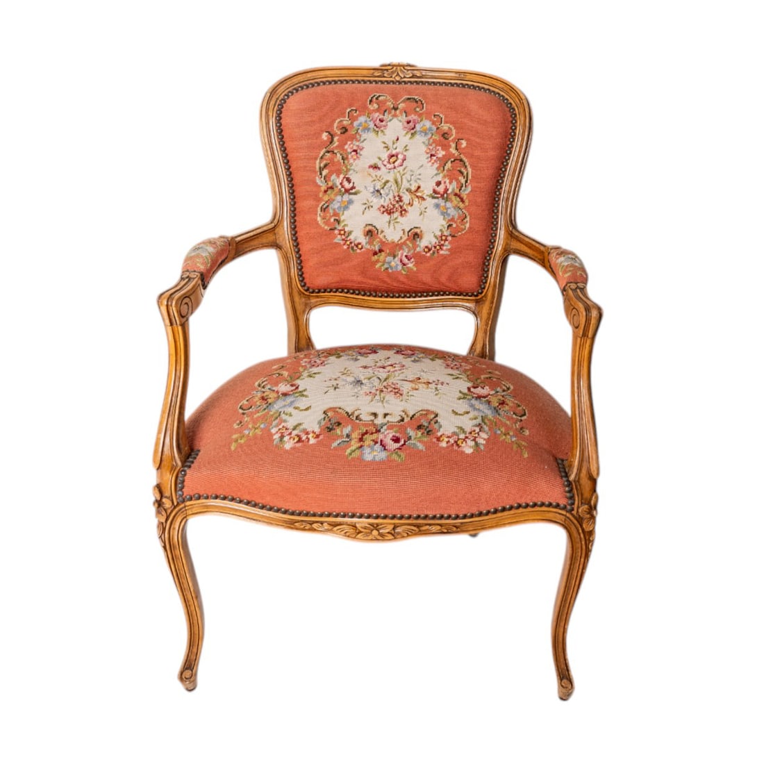 18th Century Louis XV Needlepoint Fruitwood and Tapestry Fauteuil Armchair: This 18th Century Louis XV Fruitwood Fauteuil Armchair is a beautifully crafted piece featuring hand-carved fruitwood, elegant cabriole legs, and exquisite needlepoint tapestry upholstery. Its gracefu