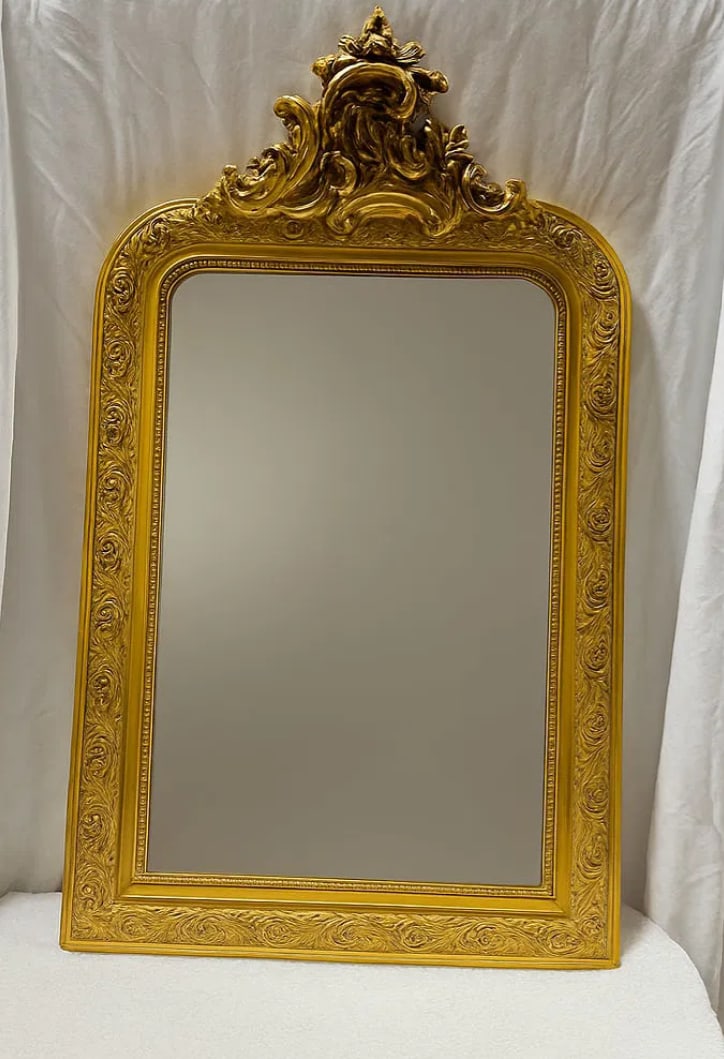 Large Late 19th Century Louis Philippe Style Carved Giltwood Mirror With Stucco Floral Motifs: This Large Late 19th Century Louis Philippe style carved giltwood mirror features an elegant gilded frame adorned with finely sculpted stucco floral motifs, characteristic of the refined decorative st