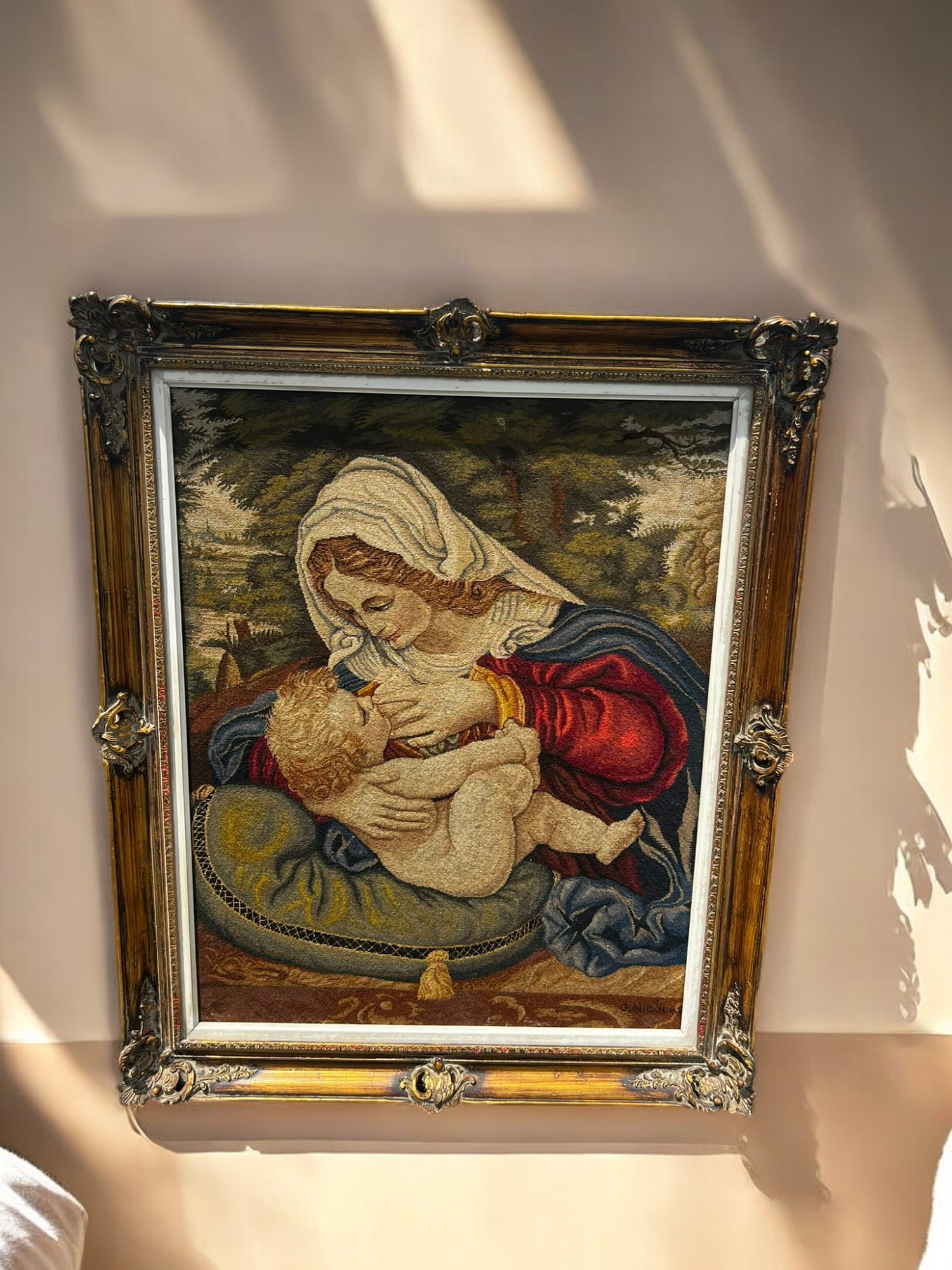 Antique Religious Needlepoint Tapestry of "Madonna with a Green Pillow" Attributed to Andrea Solario: This stunning antique religious tapestry, "Madonna with a Green Pillow," attributed to Andrea Solario iconic artwork, is a masterpiece of craftsmanship. Made of fine cotton and set in an ornate gilded