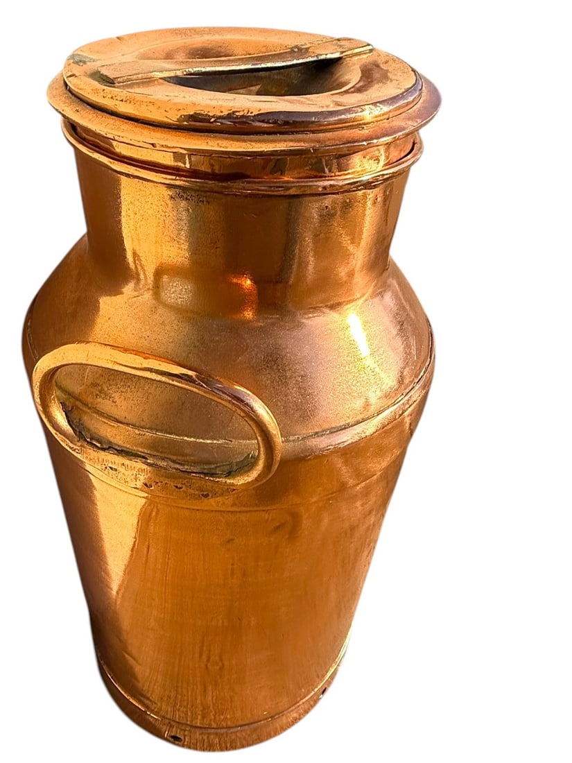 Antique Copper Milk Can, Early 1900s: This antique copper milk can from the early 1900s showcases classic utilitarian design with a rich, naturally aged patina. A wonderful decorative accent for farmhouse, industrial, or rustic interiors,