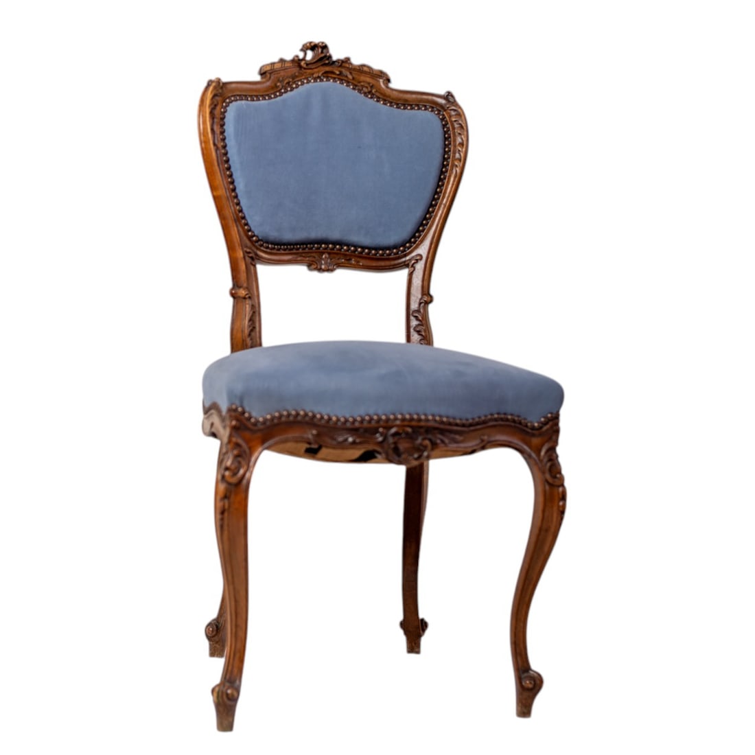 19th Century Louis XV Carved Walnut Fauteuil Armchair: This exquisite 19th-century Louis XV Fauteuil armchair showcases elegantly hand-carved walnut with gracefully curved lines and ornate detailing, embodying the timeless opulence of French design. Uphol