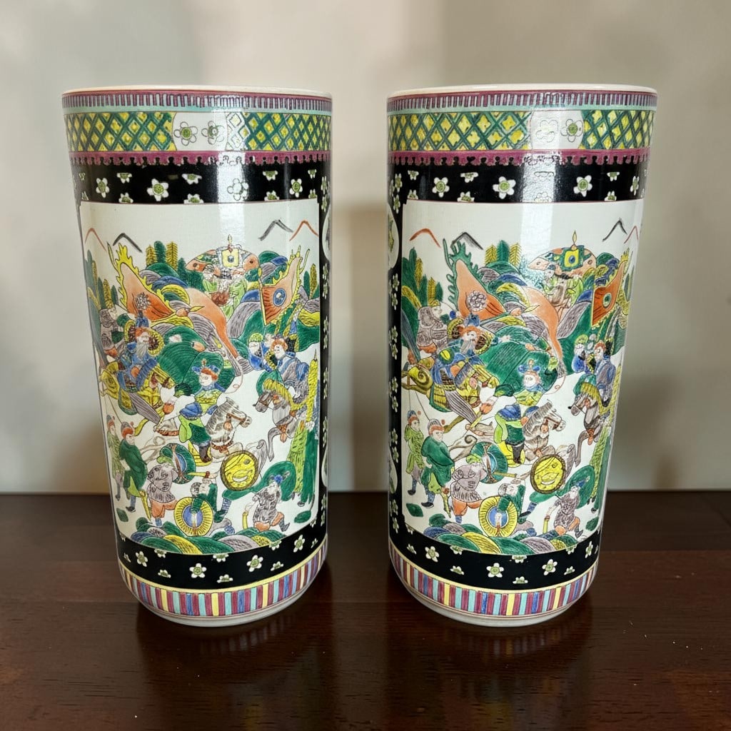 Pair of Late 19th Century Antique Qing Dynasty Chinese Famille Noire Porcelain Umbrella Stands Vases: This striking pair of Late 19th Century antique Qing Dynasty Chinese Famille Noire porcelain umbrella stands or floor vases features richly detailed hand-painted figural battle scenes rendered in vibr