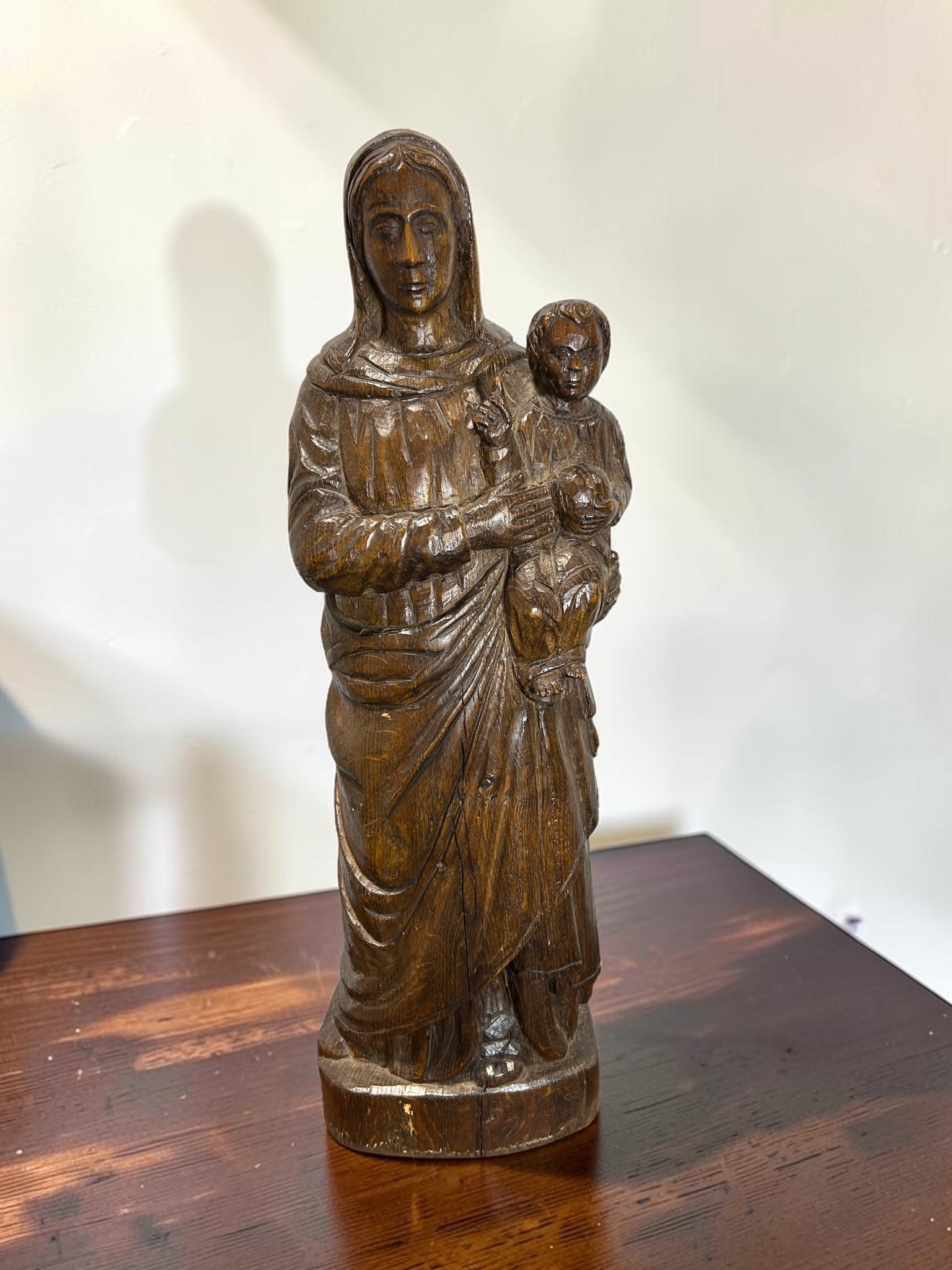 Large 16th Century Antique Hand-Carved Walnut Madonna & Child Religious Sculpture: This remarkable 16th Century antique hand-carved walnut Madonna & Child religious sculpture depicts the Virgin Mary holding the Christ Child in a serene and devotional composition inspired by traditio