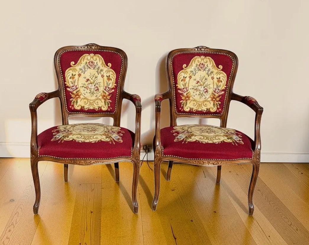 Pair of Antique French Louis XV Style Provincial Burgundy Needlepoint Tapestry Bergere Walnut Armcha: This elegant pair of antique French Louis XV style Provincial Burgundy Needlepoint Tapestry Bergere armchairs features beautifully carved solid walnut frames combined with richly detailed floral needl