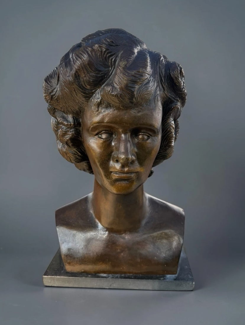 Vintage Art Deco Female Bust Sculpture Patinated Spelter Bronze Signed: Elegant vintage Art Deco female portrait bust featuring a beautifully modeled young woman with dramatic swept and waved hair, refined facial features, and a classic elongated neckline.The sculpture ha