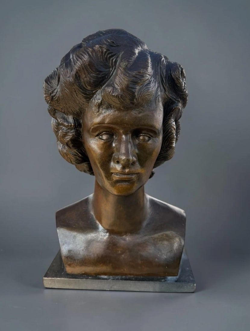 Vintage Art Deco Female Bust Sculpture – Patinated Spelter Bronze – Signed: Elegant vintage Art Deco female portrait bust featuring a beautifully modeled young woman with dramatic swept and waved hair, refined facial features, and a classic elongated neckline.The sculpture ha