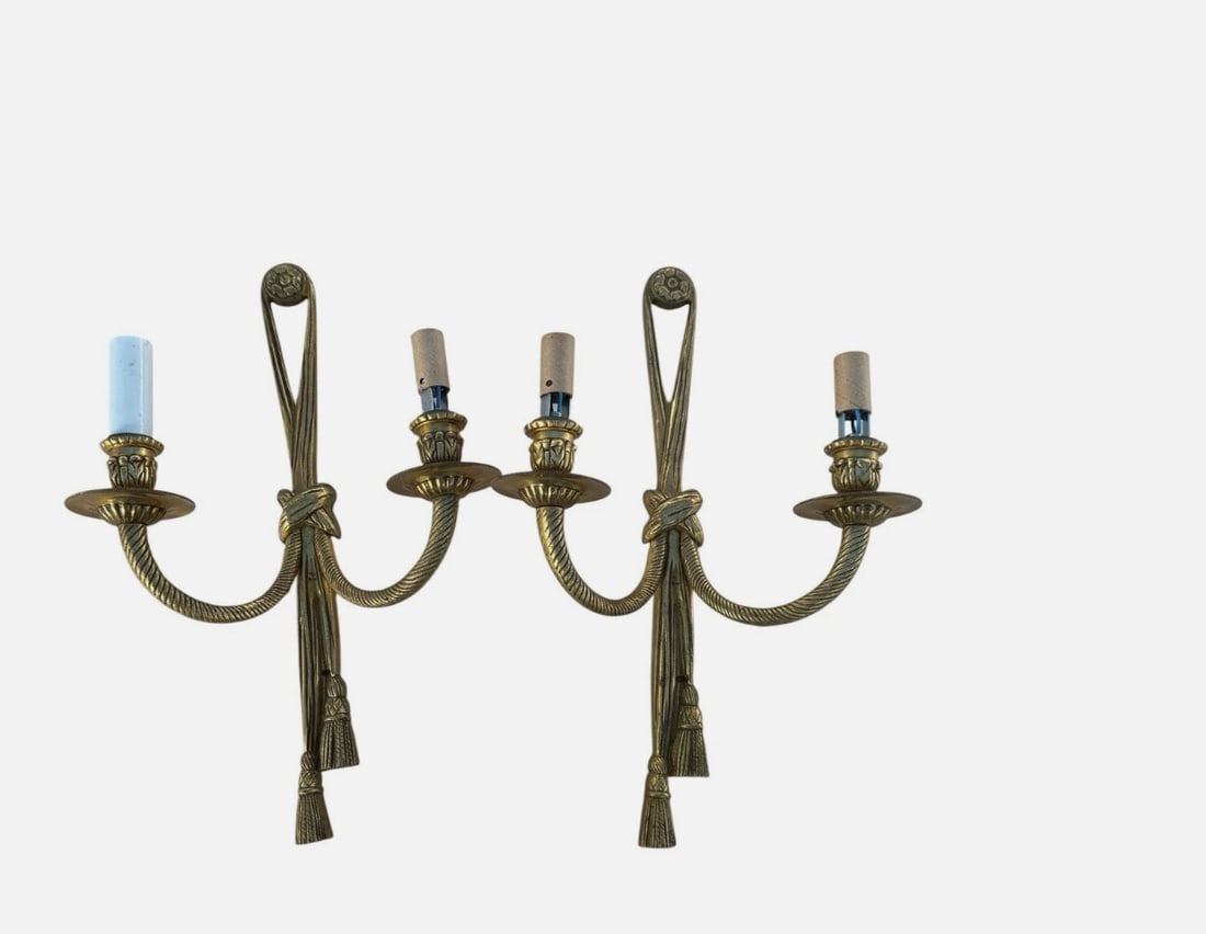 Pair of French Louis XVI Style Bronze Bow Tassel 2-Light Wall Sconces 15”: Elegant pair of two-light bronze wall sconces designed in the French Louis XVI and Neoclassical Revival style. Each sconce features a slender ribbon-form backplate crowned by a floral medallion and ti