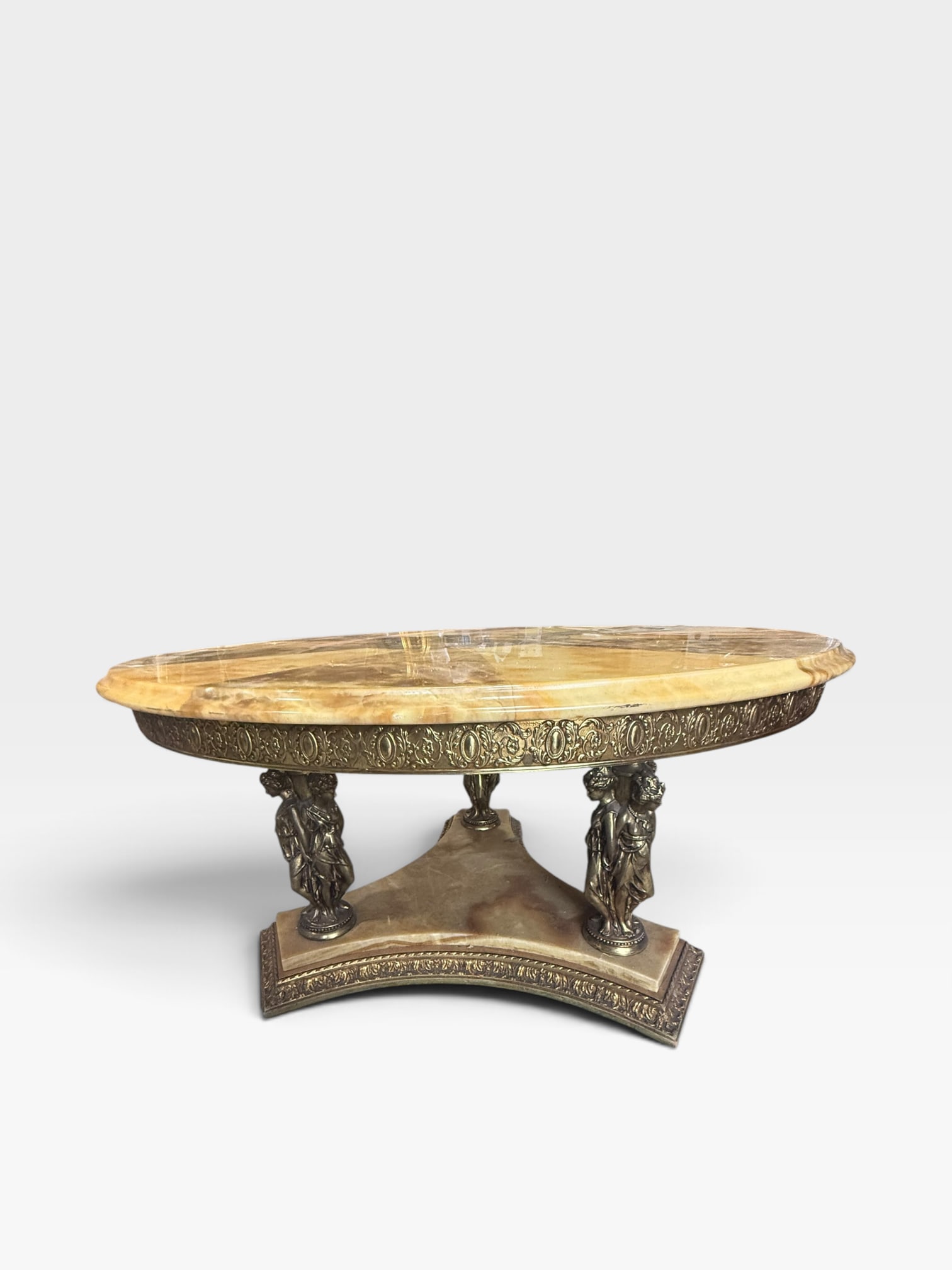 1960s French Brass & Onyx Marble Coffee Table, Greek-Roman Nymph Figural Base, Hollywood Regency: Exceptional vintage French oval coffee table dating to the 1960s, crafted from richly veined onyx marble and ornate brass\. The substantial oval stone top rests upon an elaborate sculptural base suppo