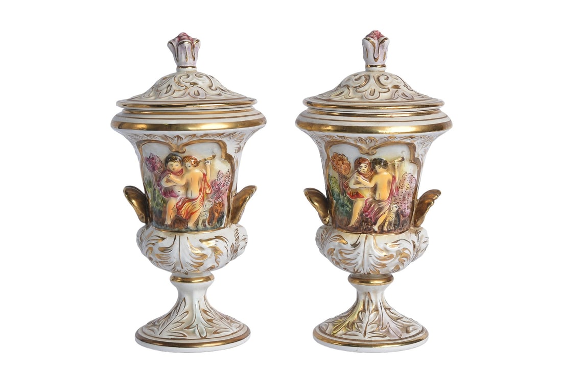 19th Century Pair of Capodimonte Cherubs Hand Painted Porcelain Cannister Urns: Enhance your decor with this exquisite pair of Capodimonte Cherubs Hand Painted Porcelain Canister Urns. Each canister features detailed cherub designs, meticulously hand-painted to capture the classi