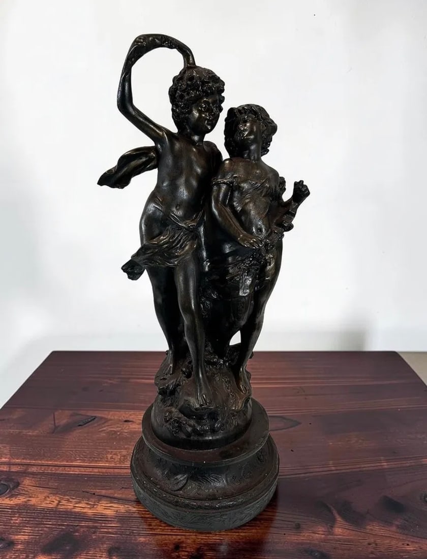Large Antique French Cold Cast Resin Bronze Patinated Putti Cherub Sculpture After Clodion Style: This elegant large antique French cold cast resin bronze patinated sculpture depicts two playful putti cherubs in a dynamic dancing pose, capturing the romantic and expressive spirit of French decorat