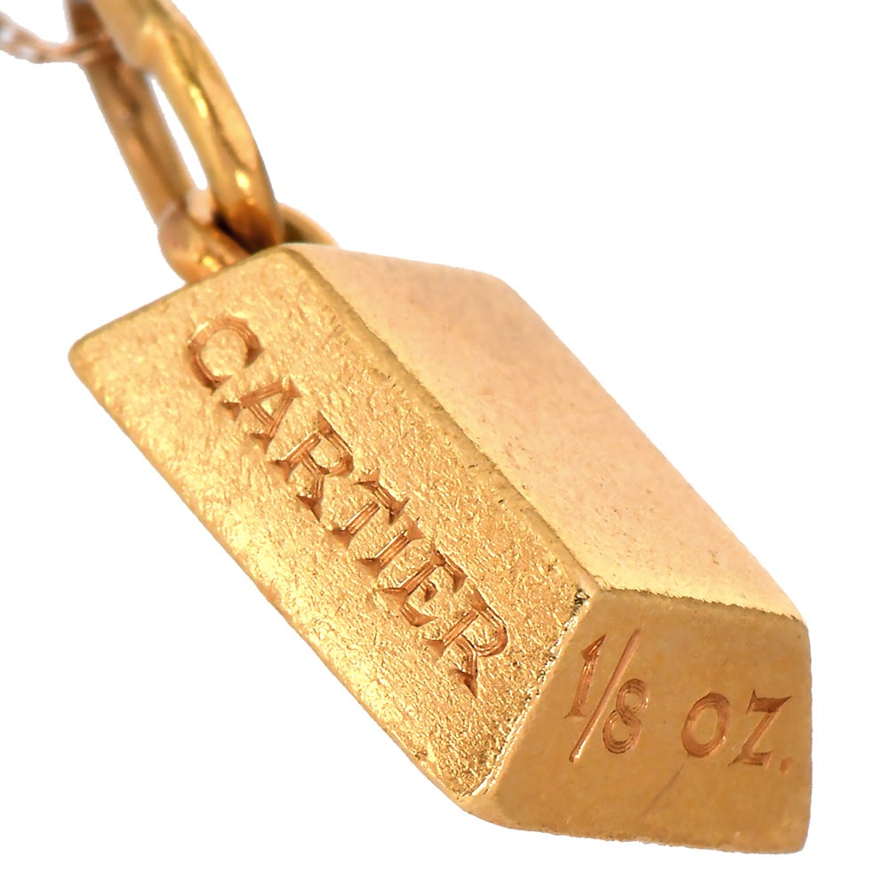Vintage 1970s Cartier 18K Yellow Gold 1/8 oz Ingot Bullion Pendant: Vintage 1970s Cartier 18K Yellow Gold 1/8 oz Ingot Bullion Pendant **Chain is NOT included.** Designer: Cartier Metal Type: 18K Yellow Gold Total Item Weight approx: 4.2 Grams Pendant Measures approx: