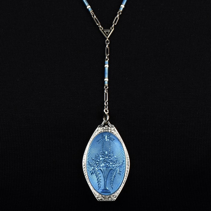 Antique Blue Enamel 18K White Gold Locket Flower Pendant Chain Necklace 31.5 Grams: A romantic antique piece from the 1930s Locket pendant necklace.The pendant has a flowers-inspired blue enameled accent, and it opens up to display a double portrait carry.The pendant is crafted in so